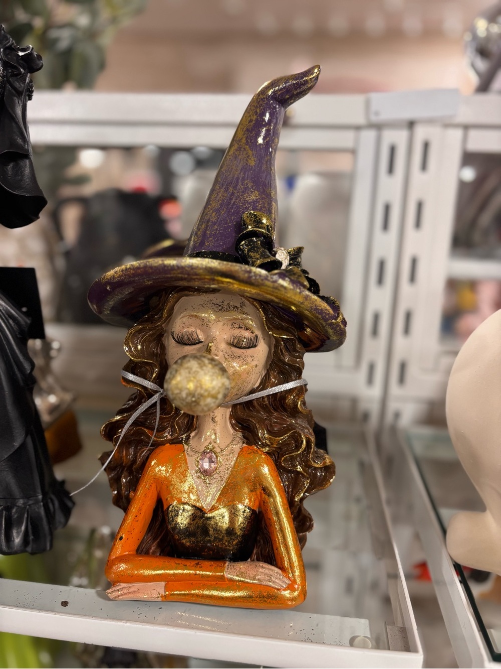 Viral Witch Bust Figurine with Purple Hat and Orange Dress blowing bubble
